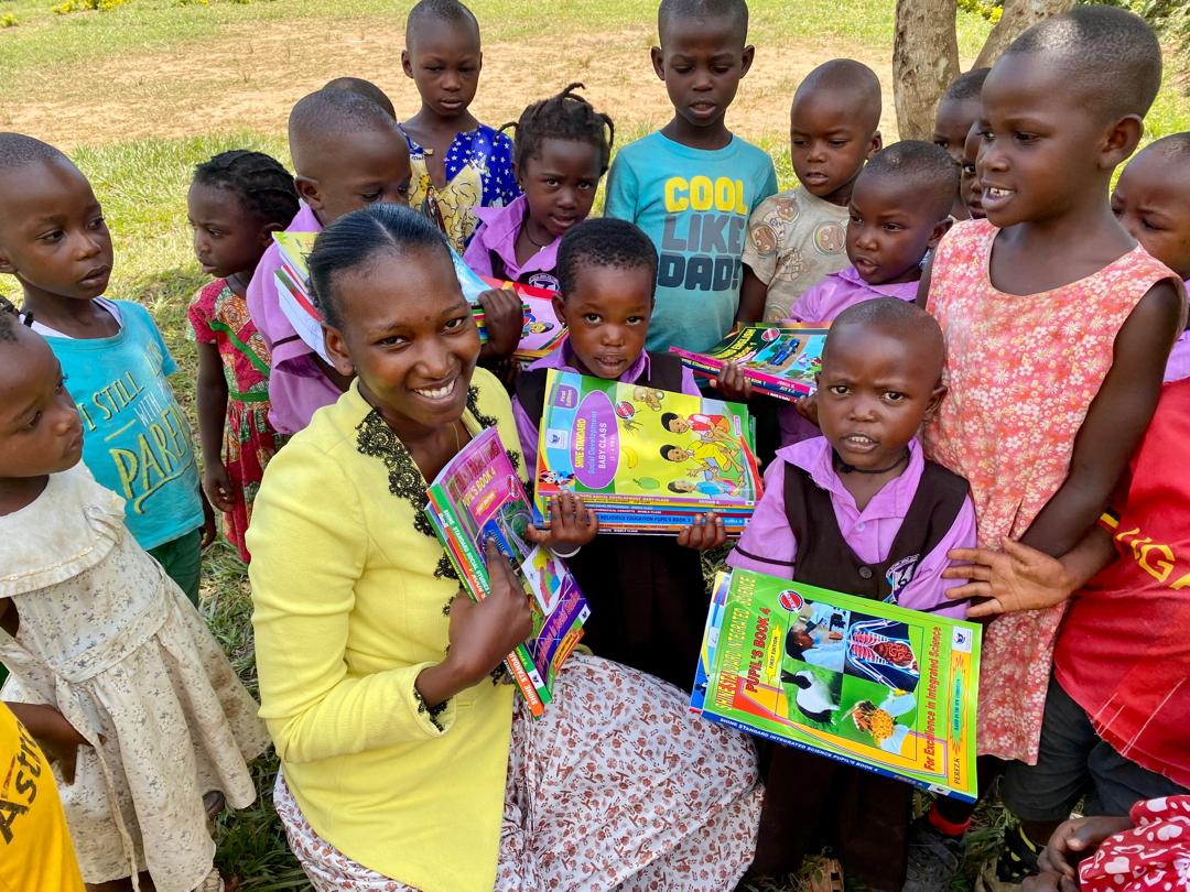 Brenda giving books to children